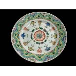 Chinese polychrome plate with stylised decoration, blue mark within two circles, 23cm.