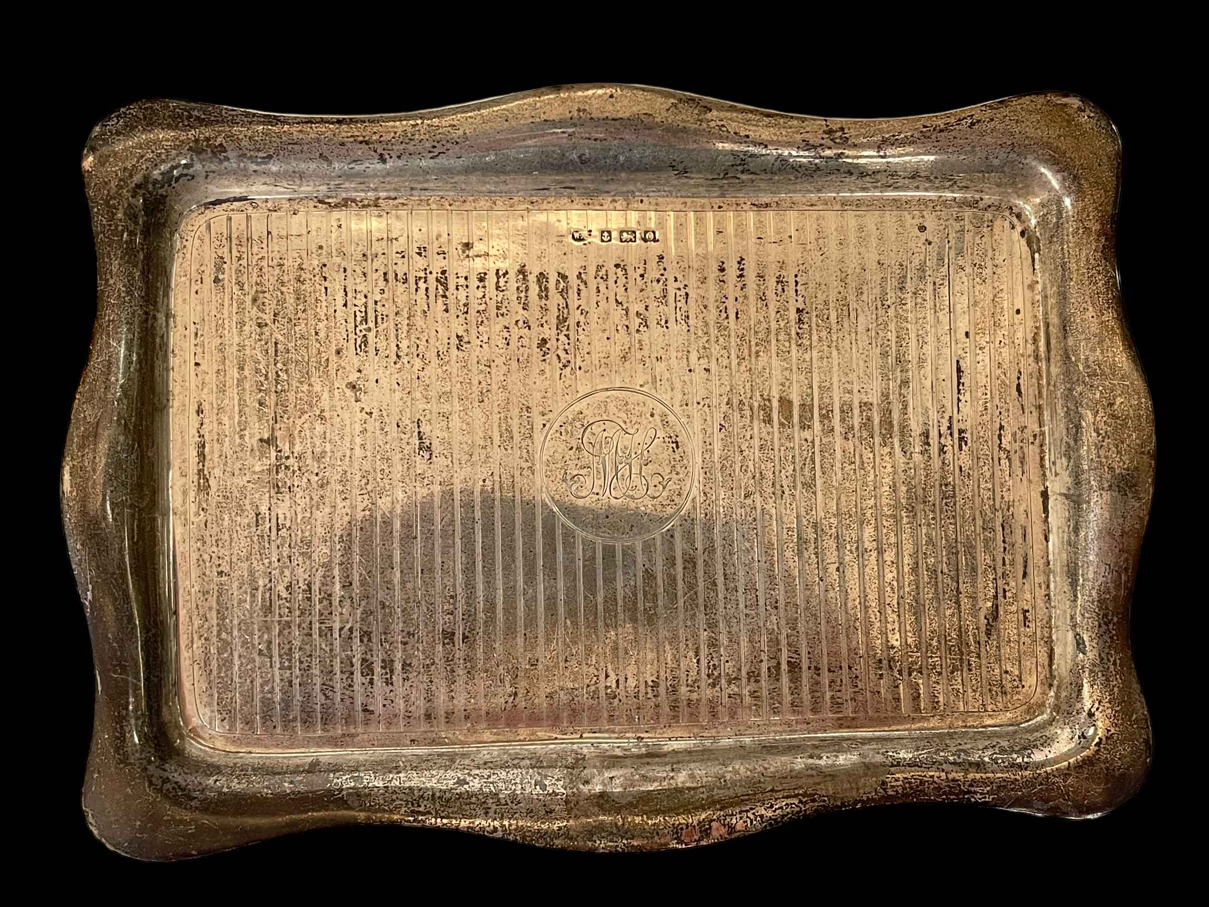 Silver serpentine-sided trinket tray, Birmingham 1938, 31cm across.