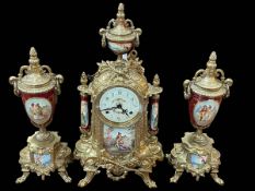 Brass and figure decorated three piece clock garniture.
