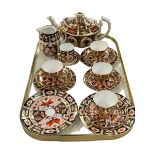 Royal Crown Derby Imari teapot, jug, five cups and saucer, and four plates.