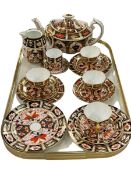 Royal Crown Derby Imari teapot, jug, five cups and saucer, and four plates.