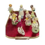 Collection of seven Freda Doughty figurines.