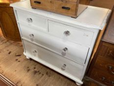 Painted pine chest of two short above two long drawers on turned legs, 86cm by 47cm by 47cm.