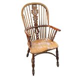 Windsor yew pierced splat back elbow chair with crinoline stretcher.