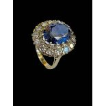 Impressive synthetic sapphire and diamond dress ring, the oval sapphire approximately 7.