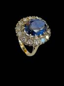 Impressive synthetic sapphire and diamond dress ring, the oval sapphire approximately 7.