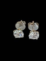Pair of diamond stud earrings set in 18 carat white gold,
