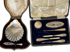 Cased silver shell shaped butter dish, London 1899 and knife, and cased silver manicure pieces,