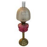 Vintage brass twist columned oil lamp with ruby glass reservoir, 71cm.