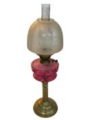 Vintage brass twist columned oil lamp with ruby glass reservoir, 71cm.