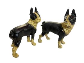 Two cast metal Boston Terrier dogs.