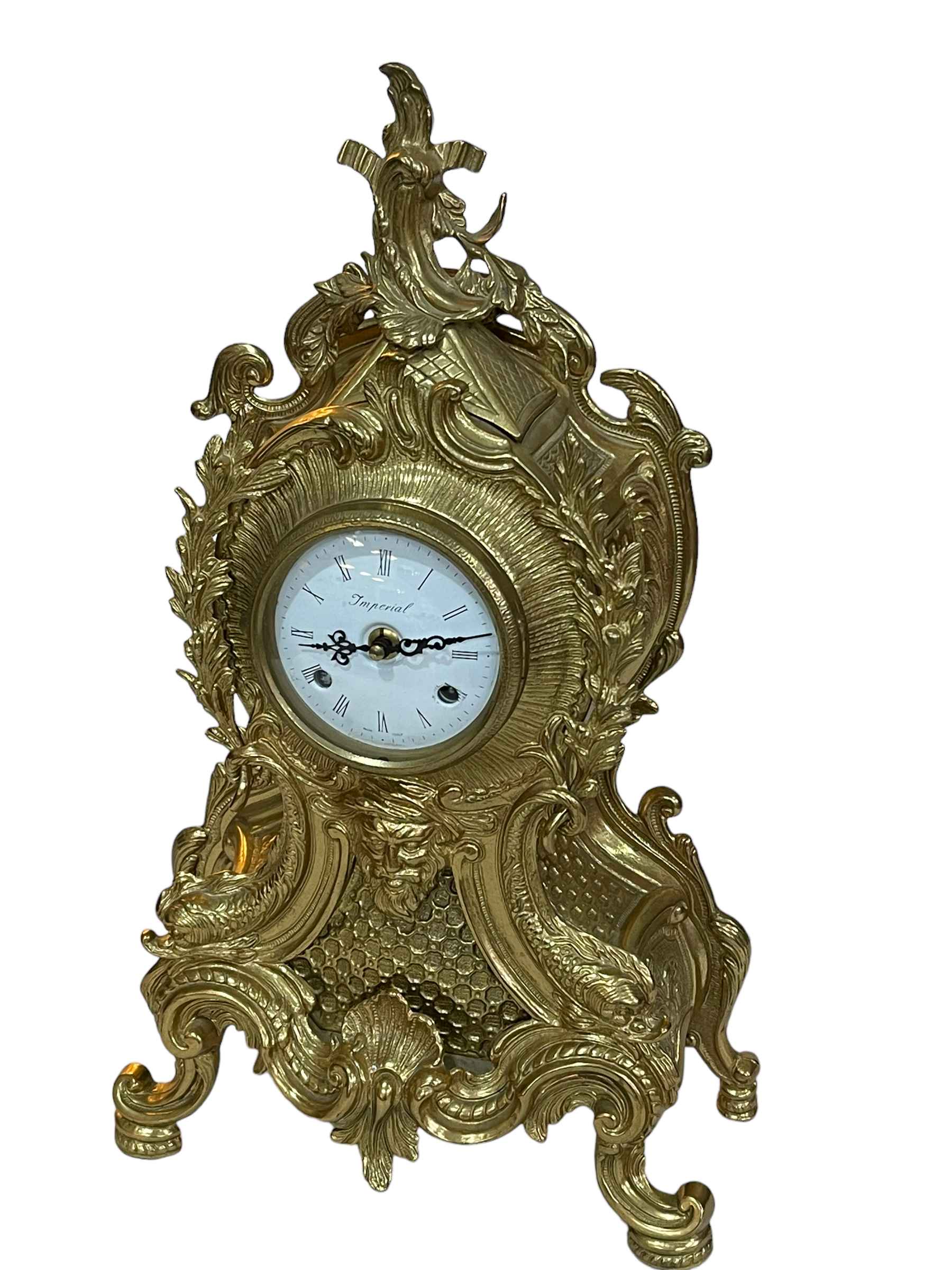 Ornate brass mantel clock with white dial, 48cm.