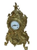 Ornate brass mantel clock with white dial, 48cm.