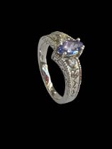 Tanzanite and diamond 14k white gold ring, size N.