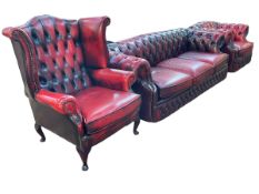 Three piece red button leather Chesterfield suite comprising three seater settee,