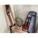 Violin with bow in case, electric guitar marked Kent, and a drum.