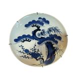 Chinese blue and white dish decorated with tree and plants, 34cm diameter.