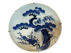 Chinese blue and white dish decorated with tree and plants, 34cm diameter.