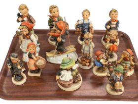 Collection of fourteen Hummel figures.