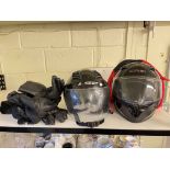 Two motorcycle crash helmets and gloves.