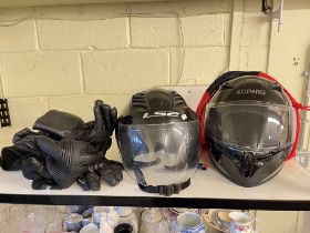Two motorcycle crash helmets and gloves.