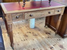Mahogany and walnut library table raised on turned reeded legs with central frieze drawer,