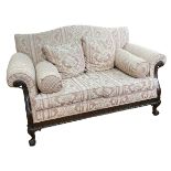 Mahogany framed Chippendale style two seater settee on ball and claw legs.