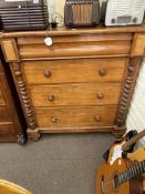 Victorian mahogany chest of four long drawers with ½ twist pillars and bun feet,