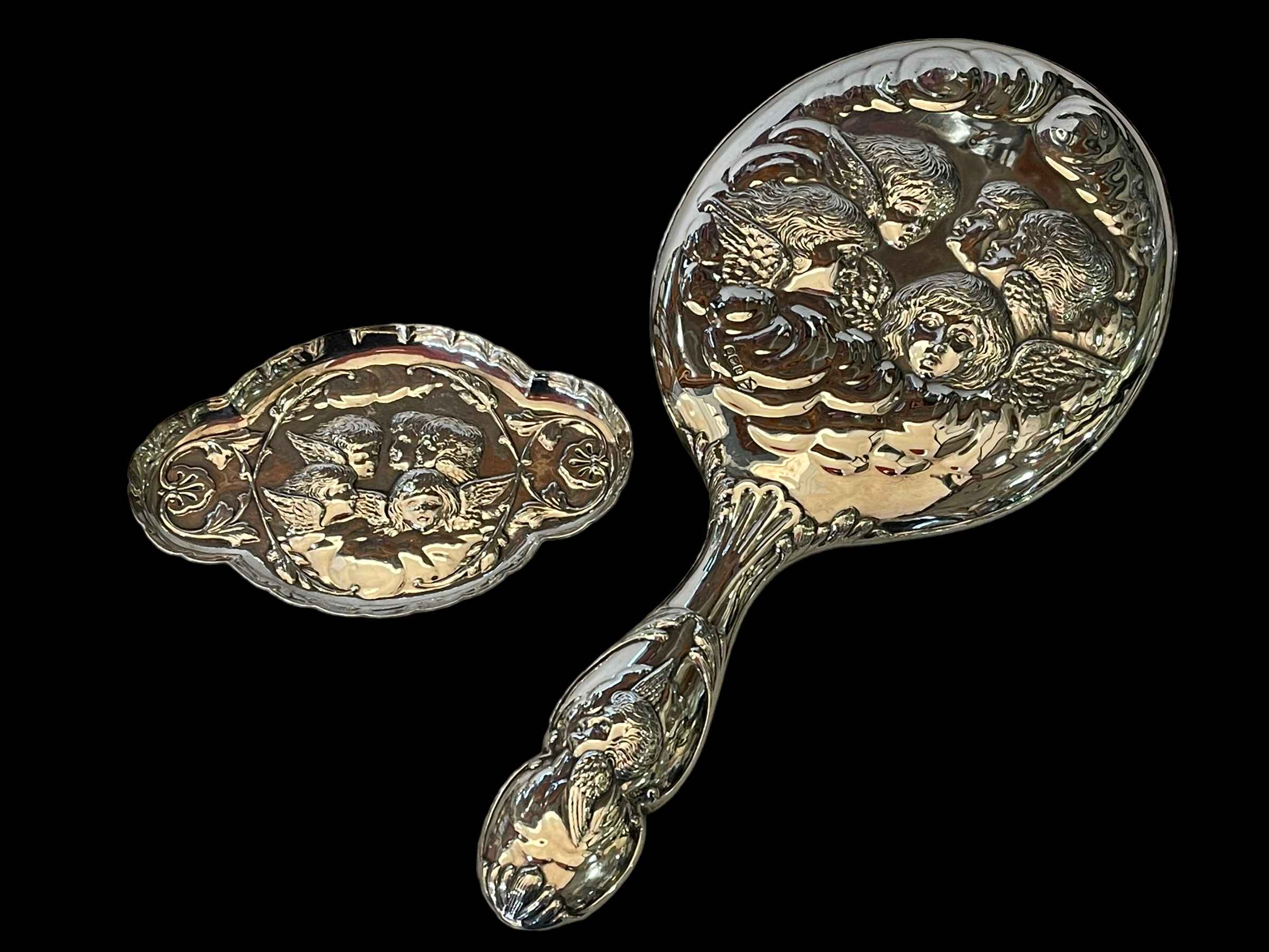 Cherub embossed silver vanity mirror, Sheffield 1912, and matching pin tray (2).