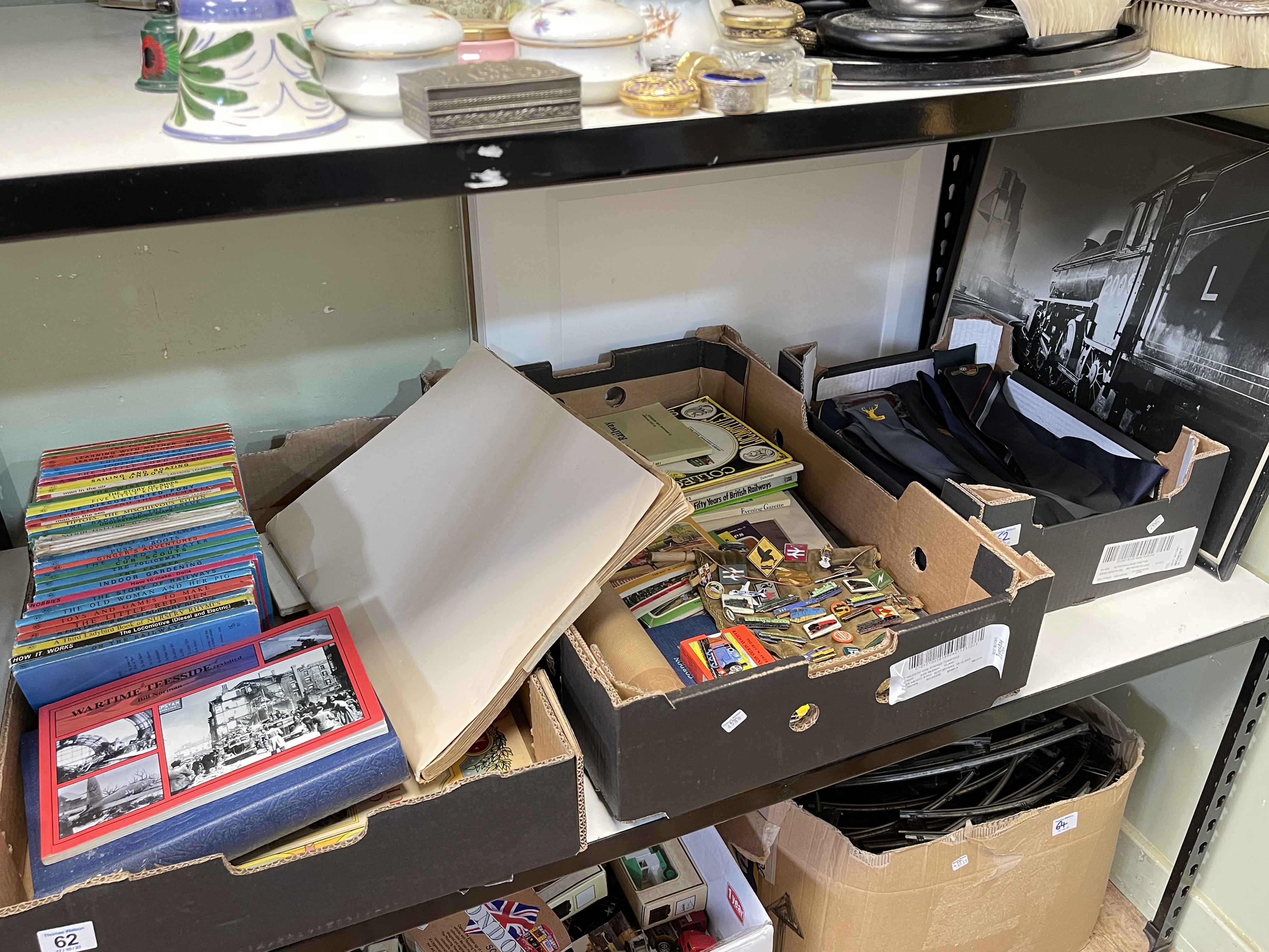 Three boxes of children's books, railway badges, railway ties, etc.