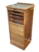 Early 20th Century light oak tambour front filing cabinet having nine internal slide out trays,