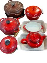 Nine Le Creuset wares including casserole dishes, baking trays, teapot, etc.