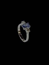 18 carat white gold, sapphire and diamond three stone ring, the central baguette cut sapphire 0.
