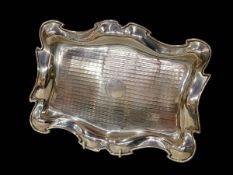 Edwardian silver dressing table tray with shaped border, Birmingham 1909, 31cm across.