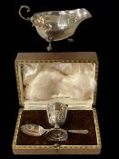 Silver sauce boat, Birmingham 1913 and cased silver egg cup and spoon, Sheffield 1928.