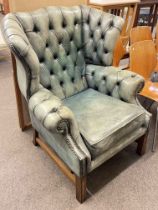 Deep buttoned and brass studded leather Georgian style wing armchair,