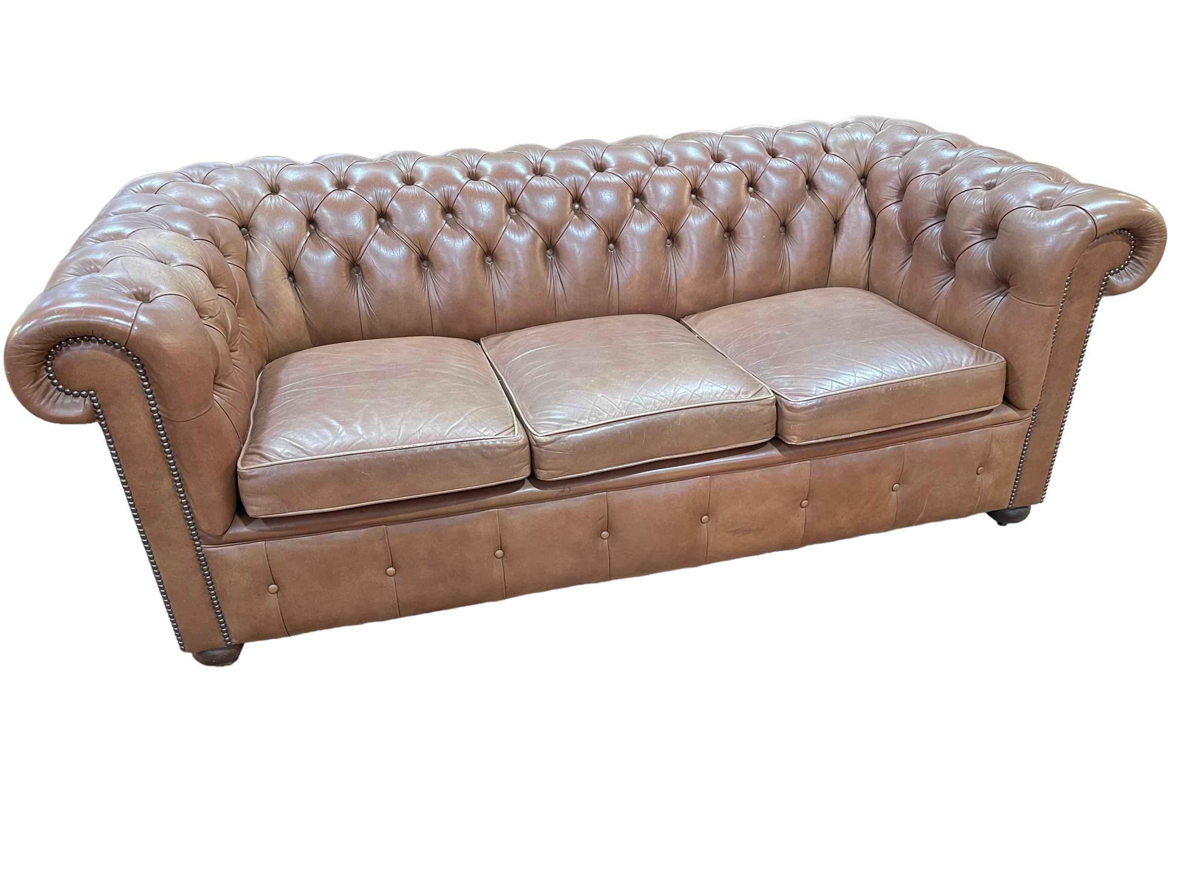 Millbrook tan deep buttoned leather three seater Chesterfield settee, 192cm by 71cm by 93cm.