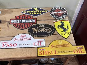 Seven cast iron motorcycle interest signs.