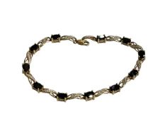 Diamond and dark blue/black stone 9 carat gold bracelet, 19cm.