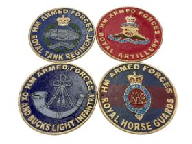 Four cast iron military plaques.