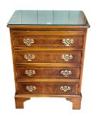 Ian Smith reproduction walnut crossbanded bachelors chest having plate glass top above a brush