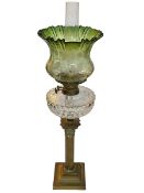 Vintage brass columned oil lamp with green shade, 74cm.