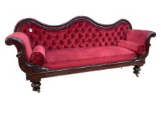 Victorian mahogany double scroll end settee with serpentine arched back in wine coloured deep