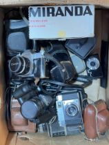 Box of assorted cameras including Canon.