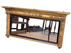 Regency gilt and ebonised triple mirror panelled overmantel, 77cm by 150cm.