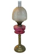 Vintage brass twist columned oil lamp with ruby glass reservoir, 71cm.