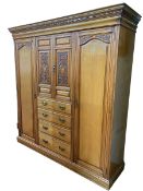 Victorian carved ash combination wardrobe having two central carved panel doors above four drawers