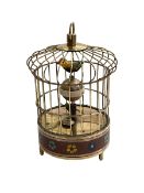 Reproduction clockwork bird in cage.