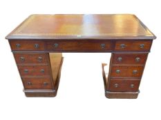 Late Victorian mahogany nine drawer pedestal desk with gilt tooled brown leather inset top,