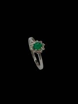 Emerald and diamond cluster ring set in 18 carat yellow gold, emerald 0.32 carats, diamond 0.